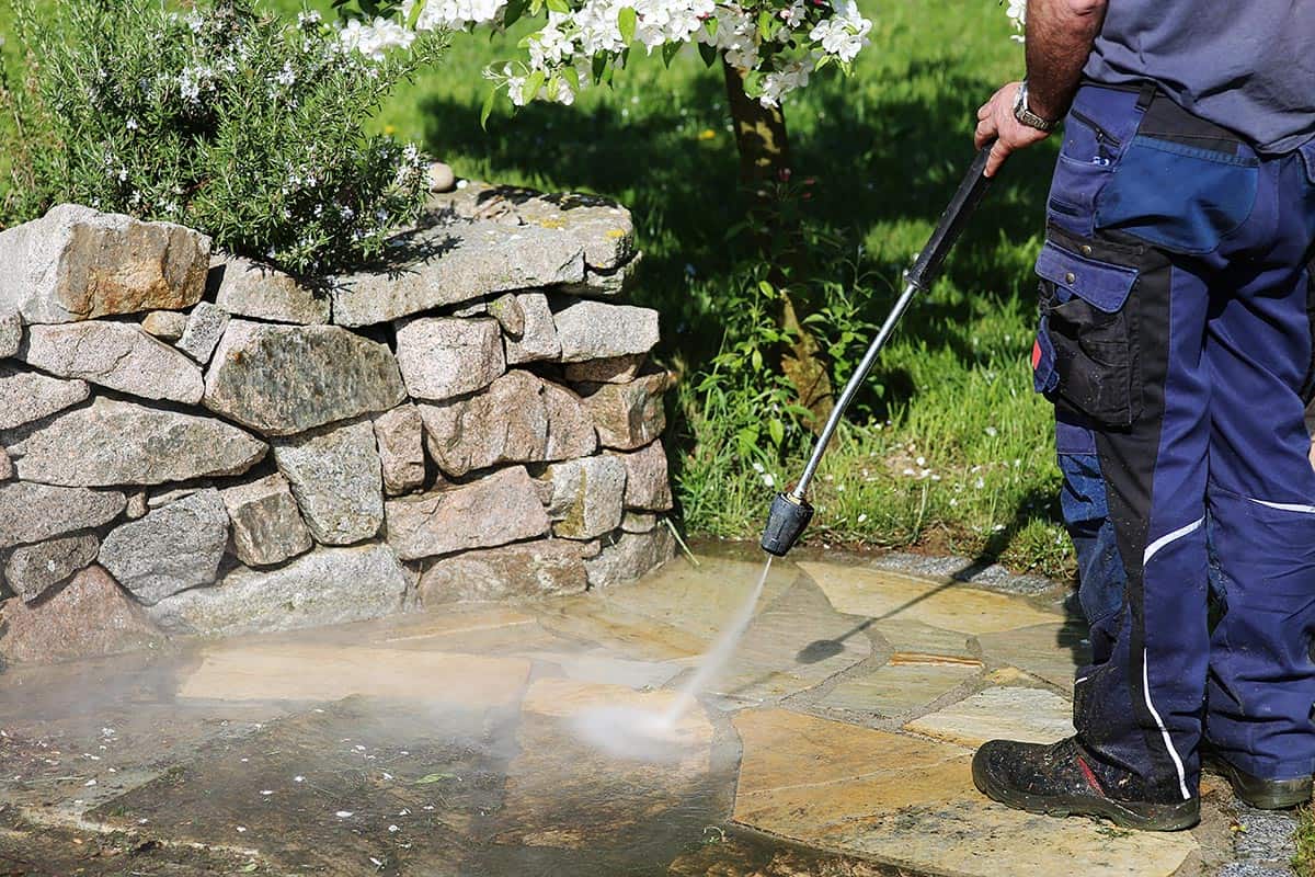 Cleaning of stones in the garden with the high-pressure cleaner