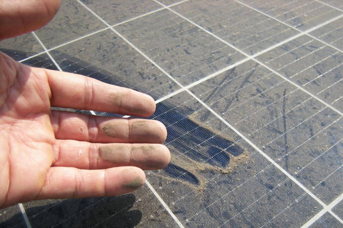 Dirty hand after rubbing dusty solar panel
