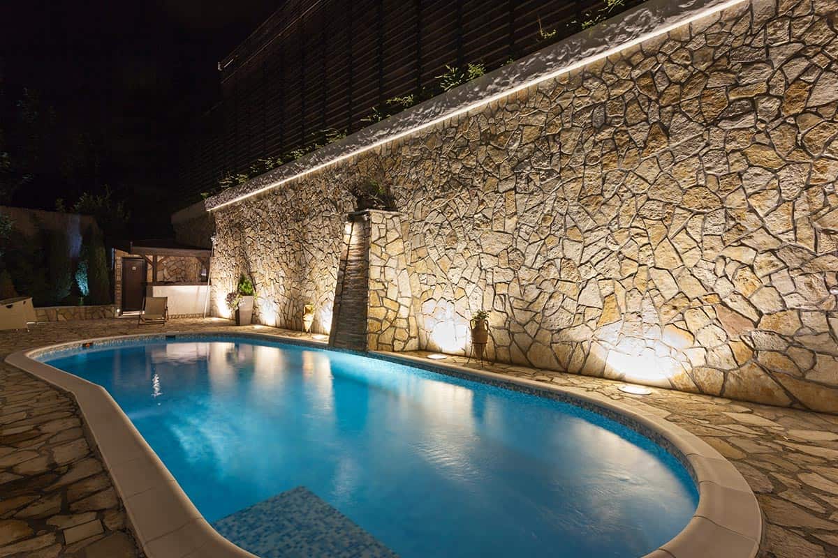 Modern outdoor private swimming pool at night