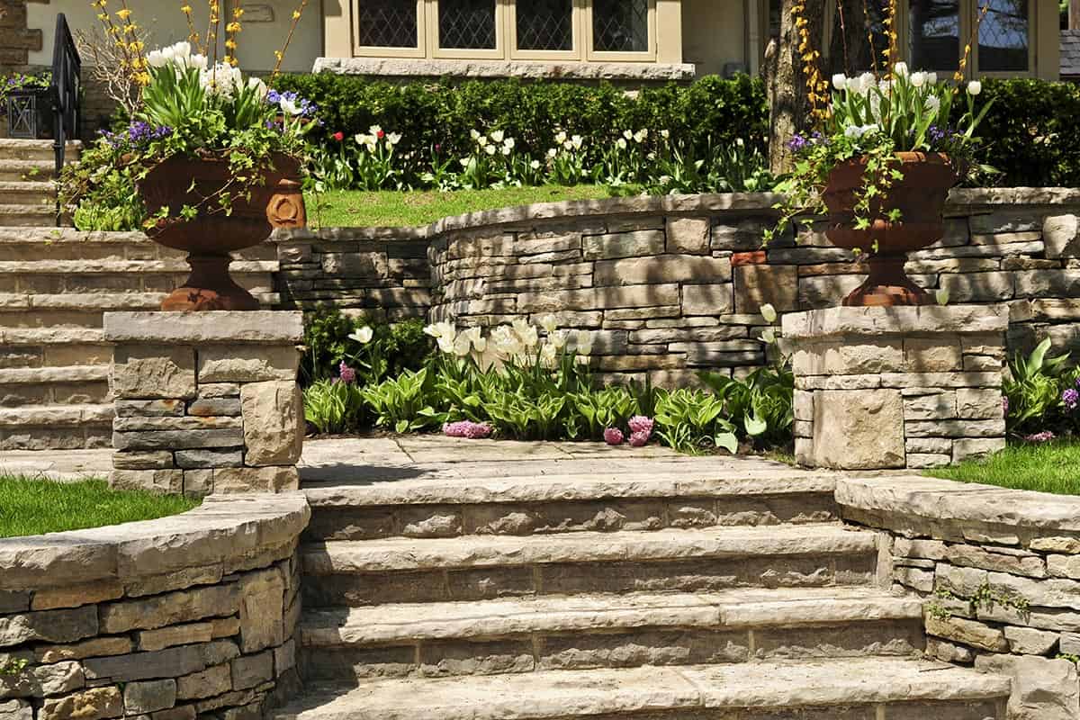 Natural stone landscaping of walls and steps outside house
