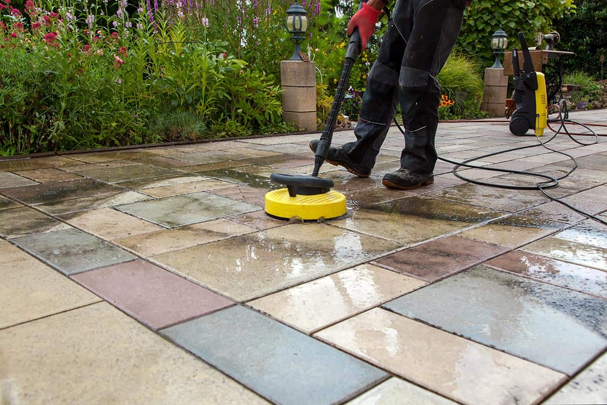 Person worker cleaning the outdoors floor