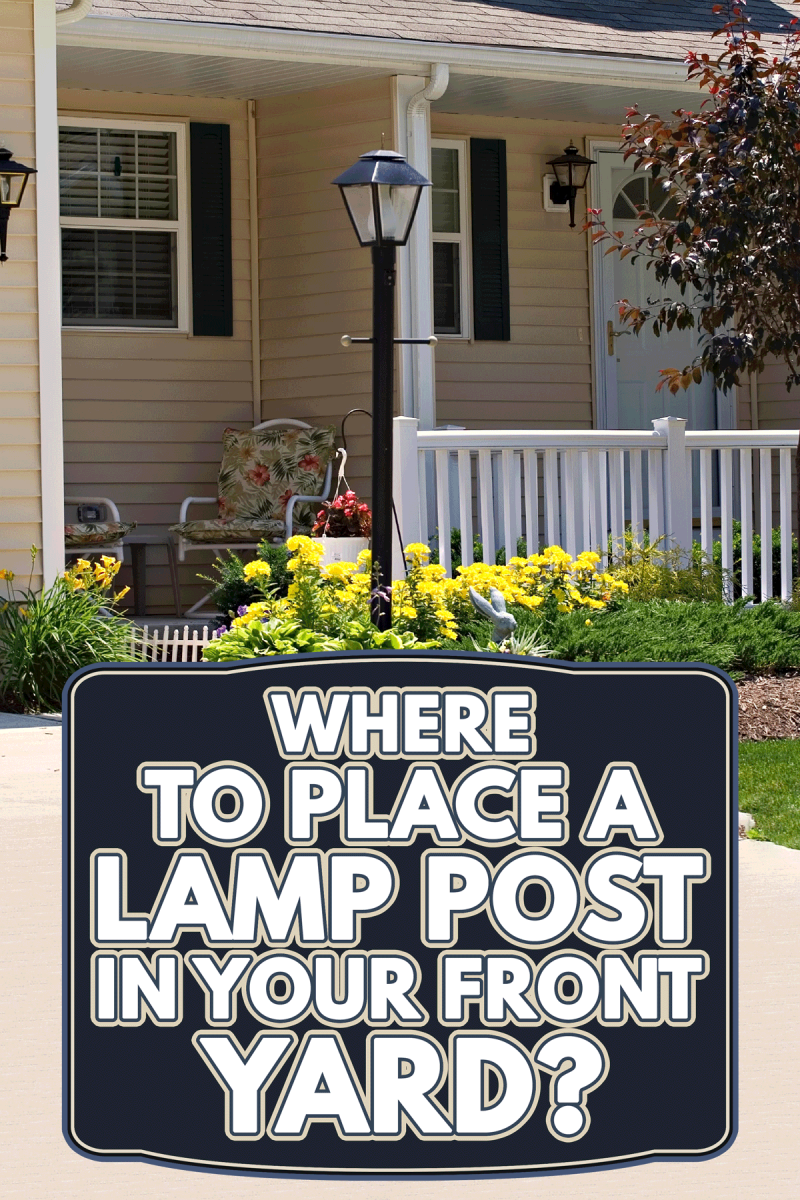 A small home with a white fence and lamp post on the front yard, Where To Place A Lamp Post In Your Front Yard?