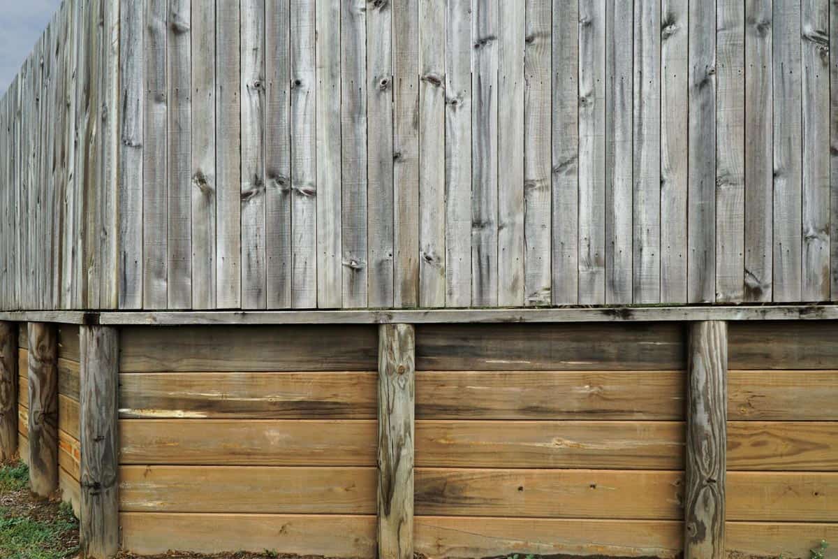 Wooden fence around a home for home security and retainer wall
