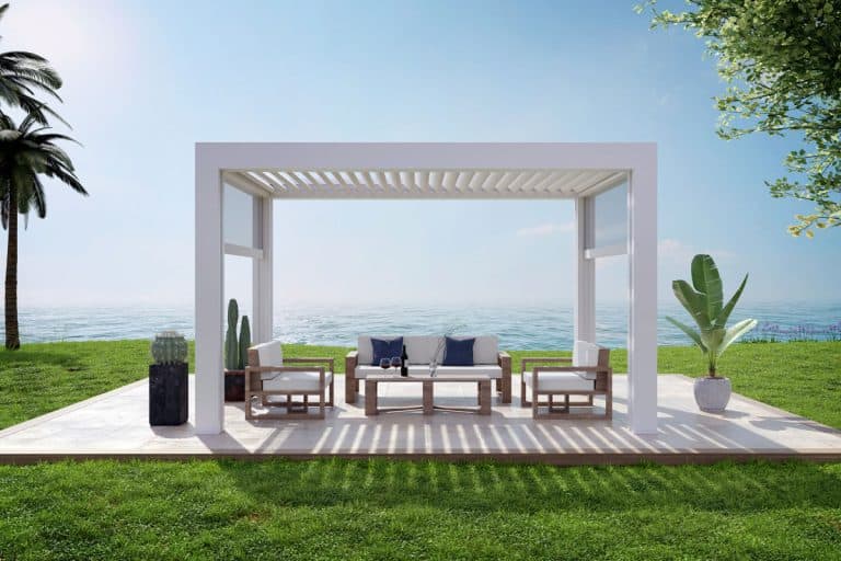 luxury deck on grass plain with white bio climatic pergola, Cozy sofa set with coffee table, palm trees and relaxing, Should Patio Be Level Or Sloped? [And By How Much]