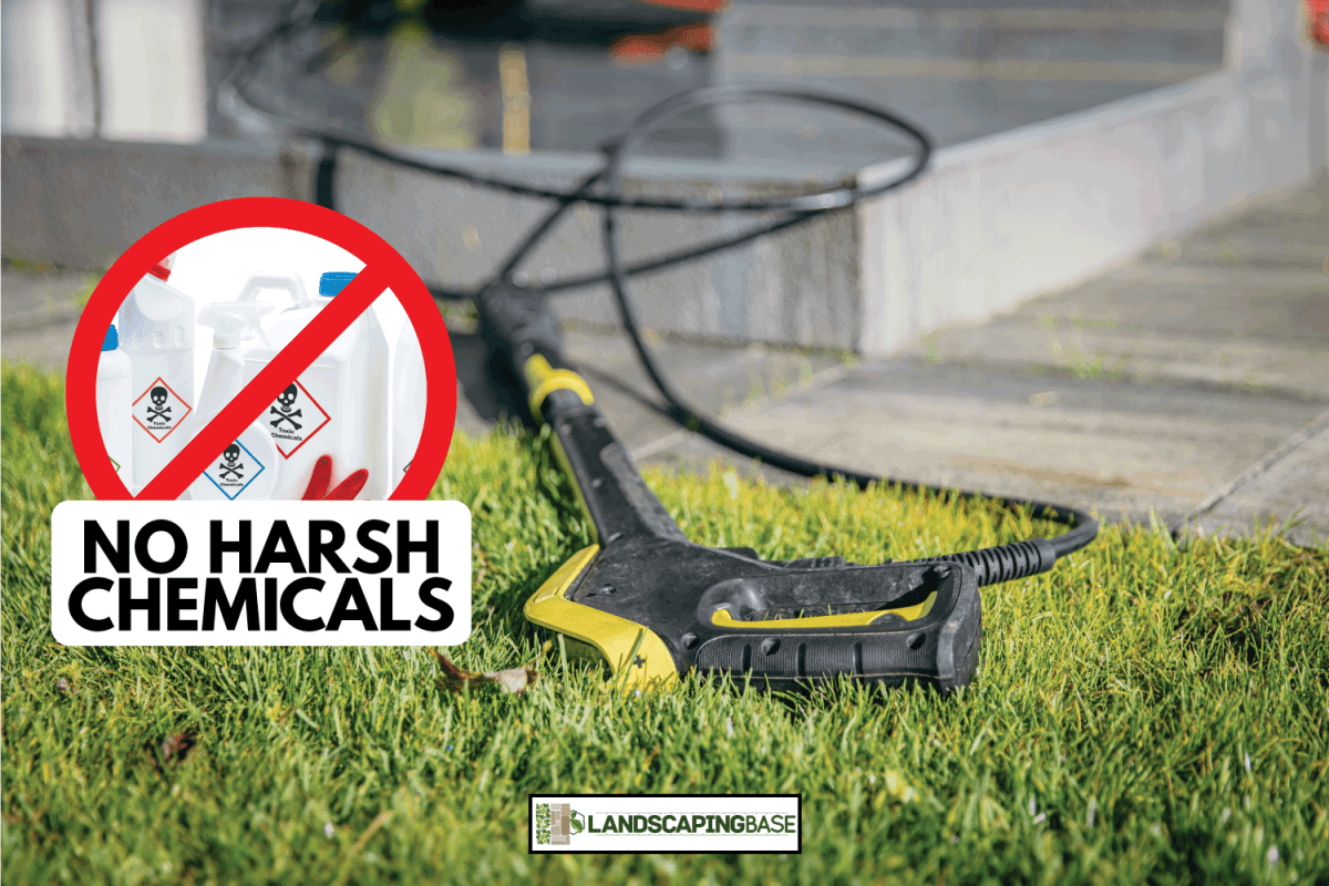 pressure washer gun laying on the artificial grass. in set photo of harsh chemicals with warning sign. Will Patio Cleaner Damage Artificial Grass