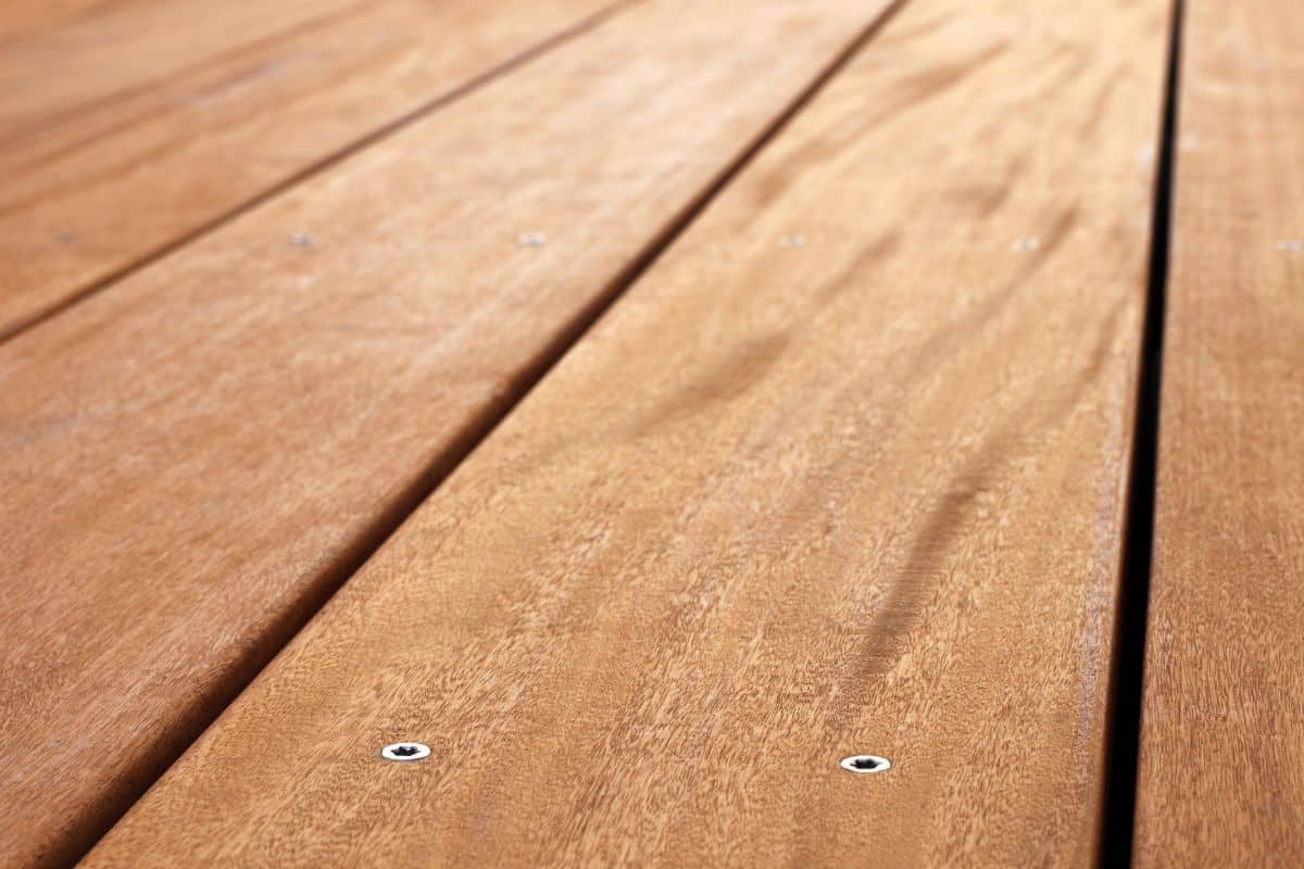 Close up of a veranda floor, made from garapa wood. With shallow depth of field.