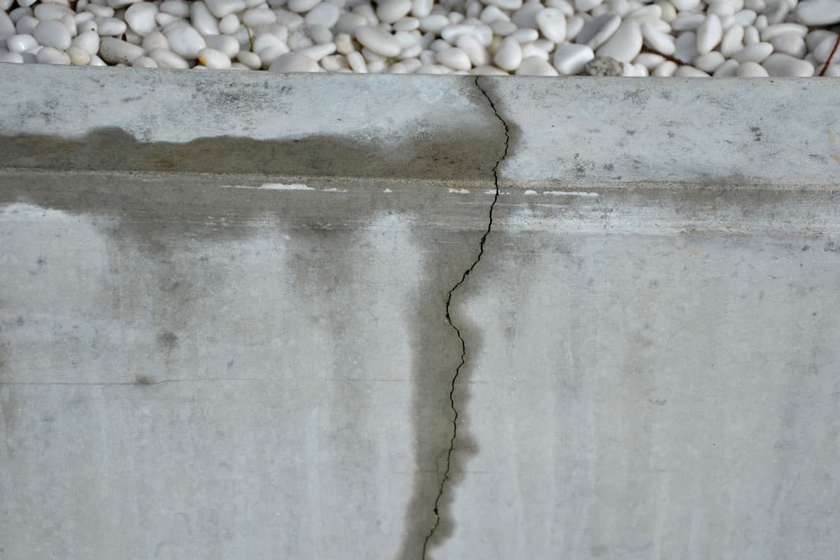 cracked retaining wall, water come out, long crack