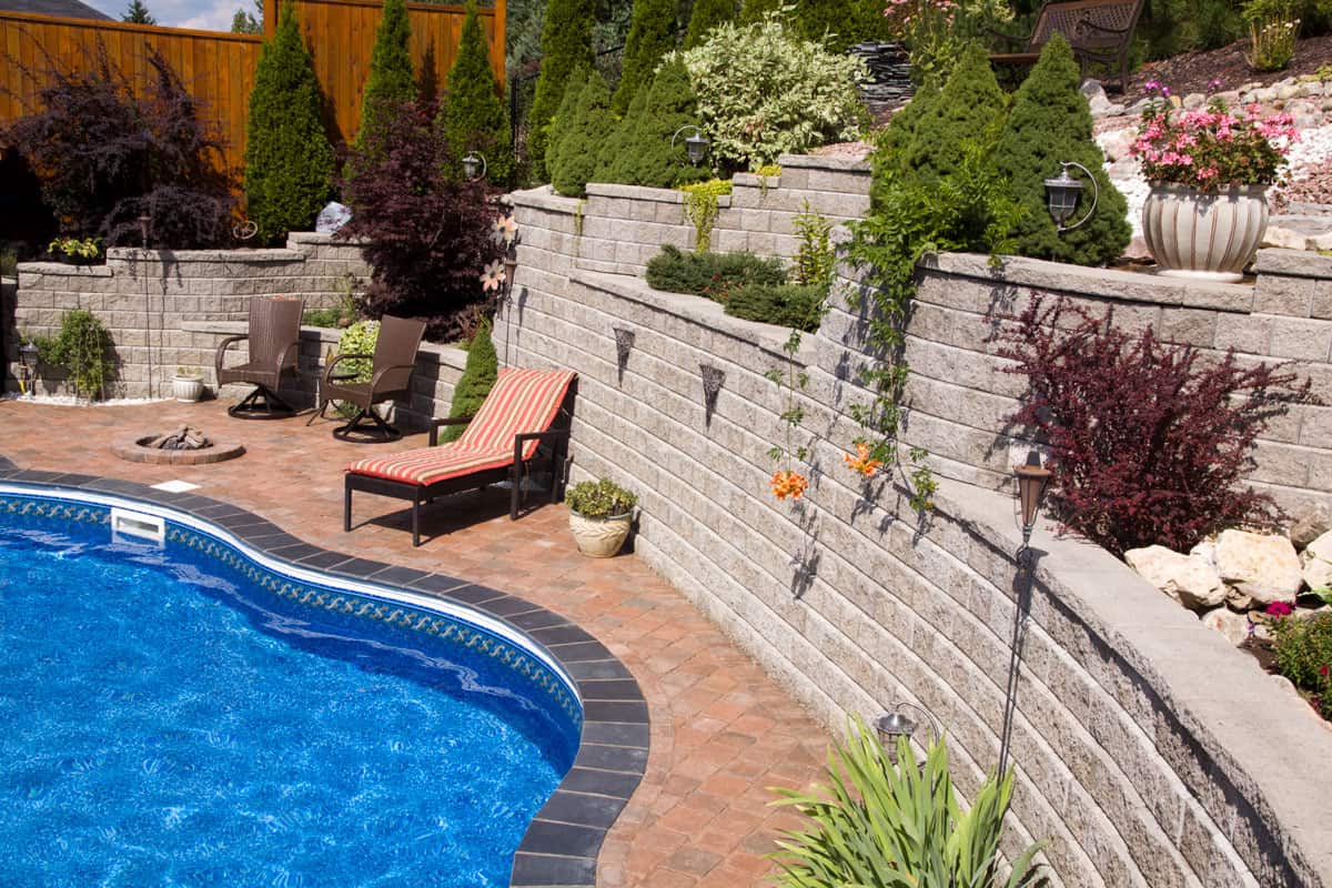 photo of a retaining wall located beside the pool at the back yard of the house