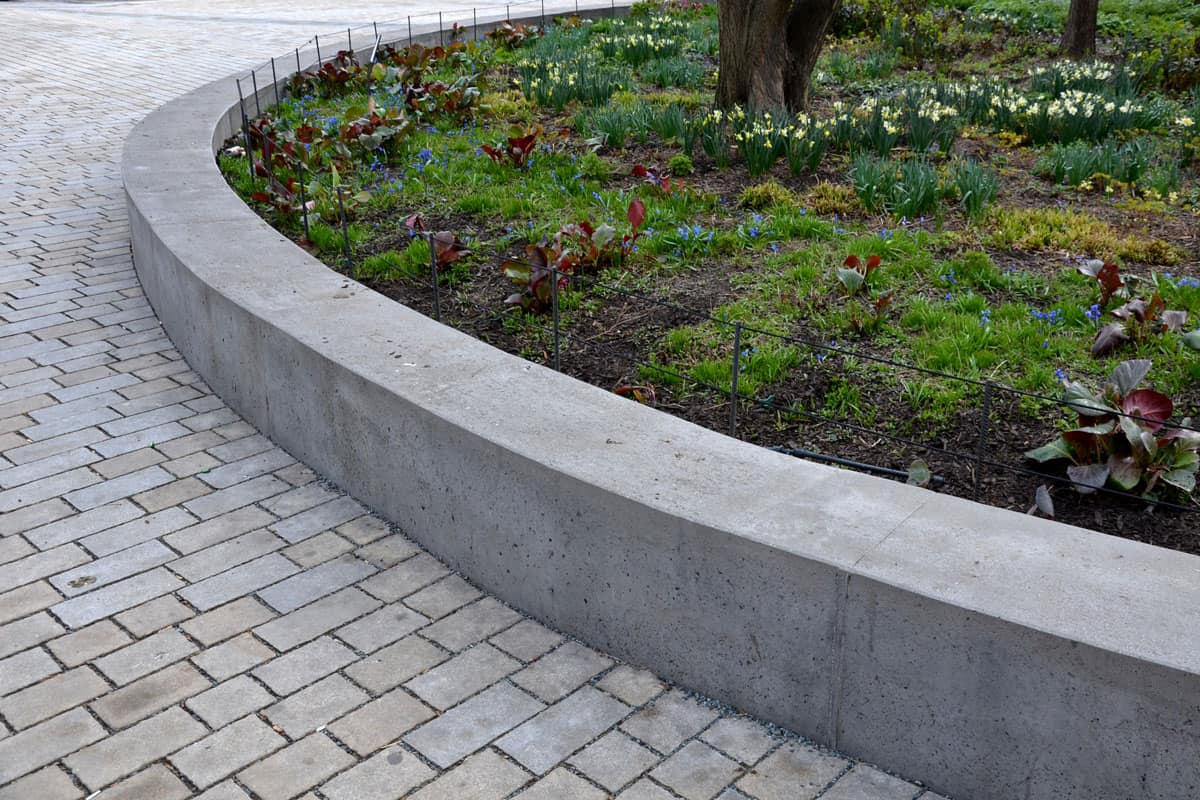 photo of a retaining wall located beside the sidewalk of the park