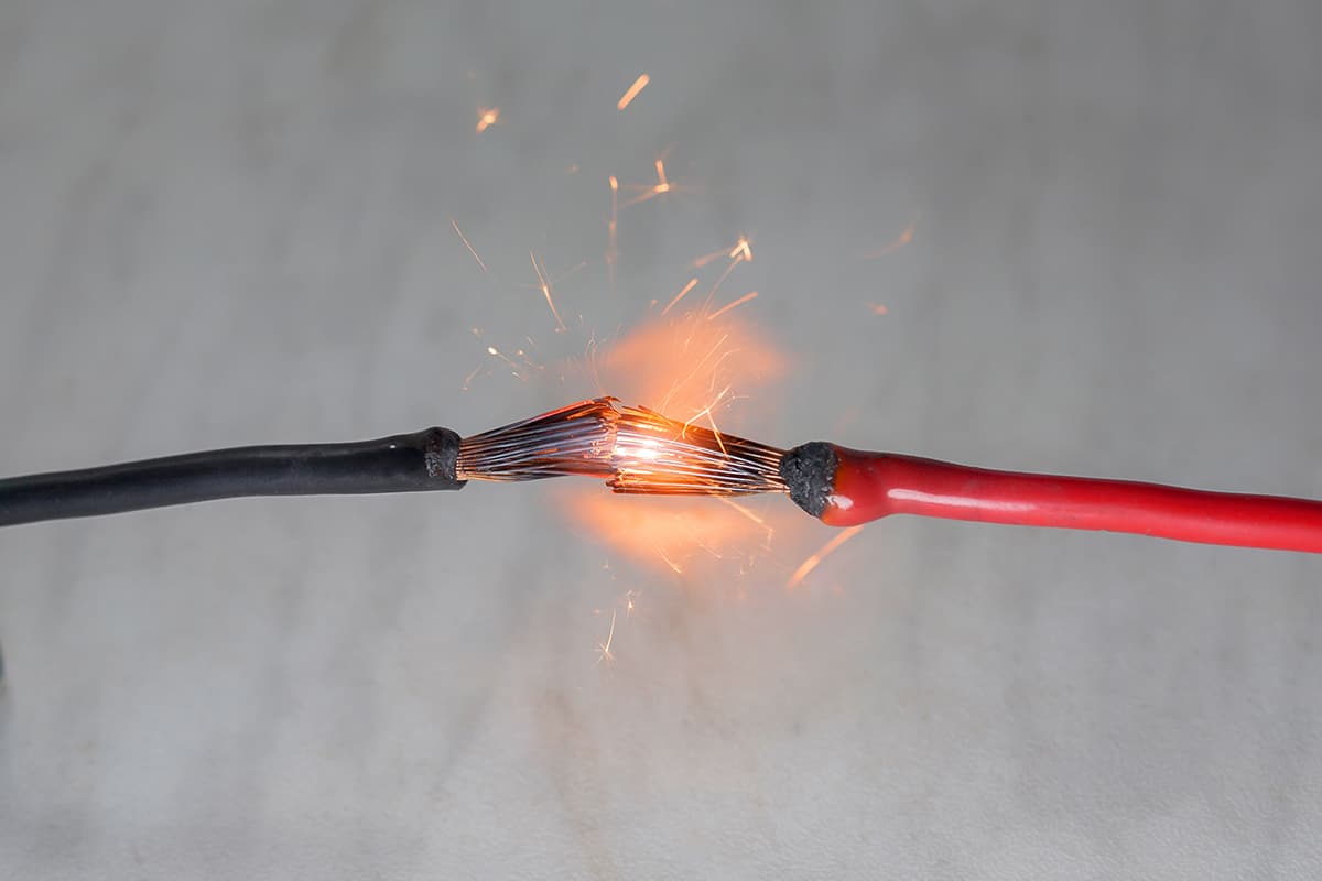 Short circuit of electrical wires sparks molten wires